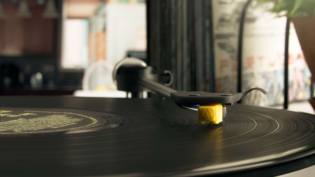 A close-up of a vintage record player's turntable platter with tonearm resting in the rest position