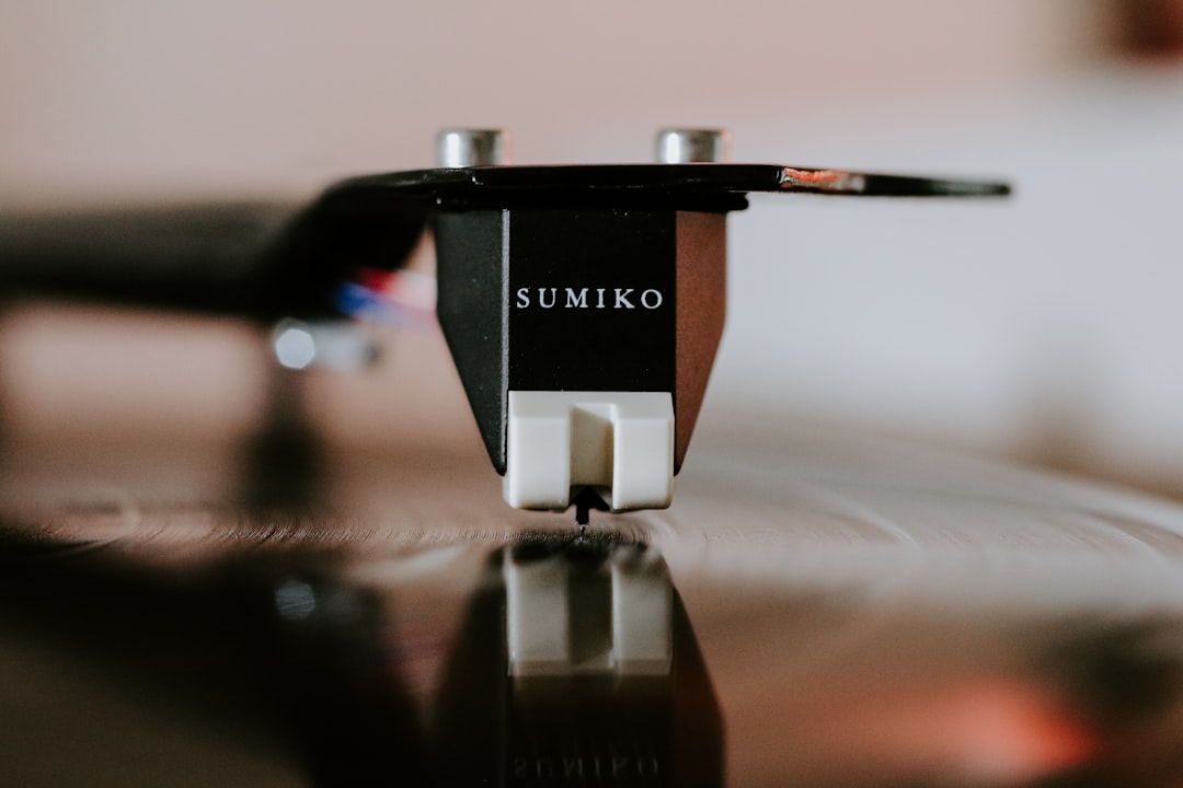 Close-up of a turntable needle tracing a vinyl record groove
